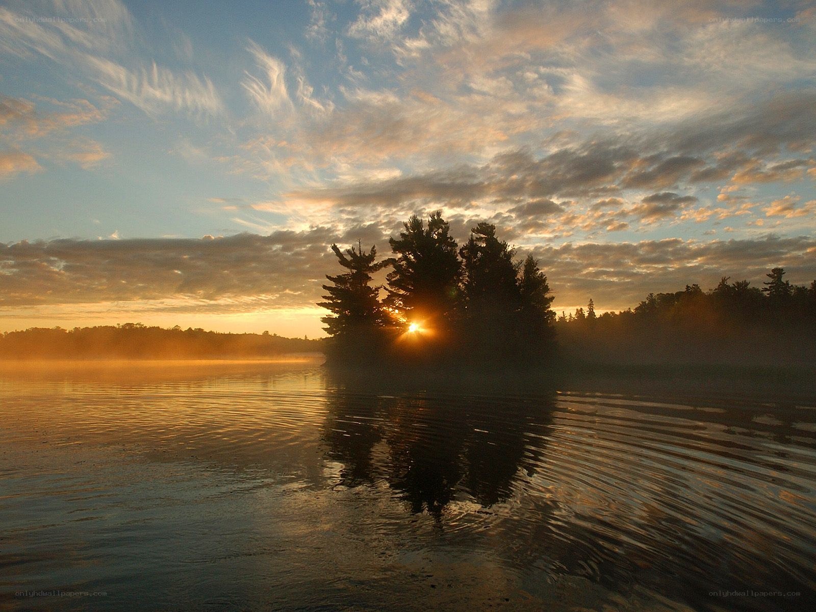 Sunrise over a misty lake