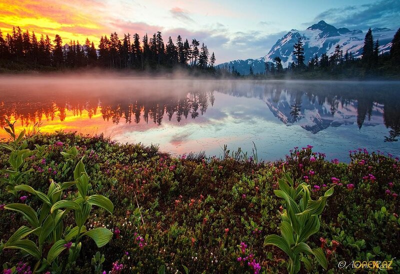 Sunrise over a misty mountain lake