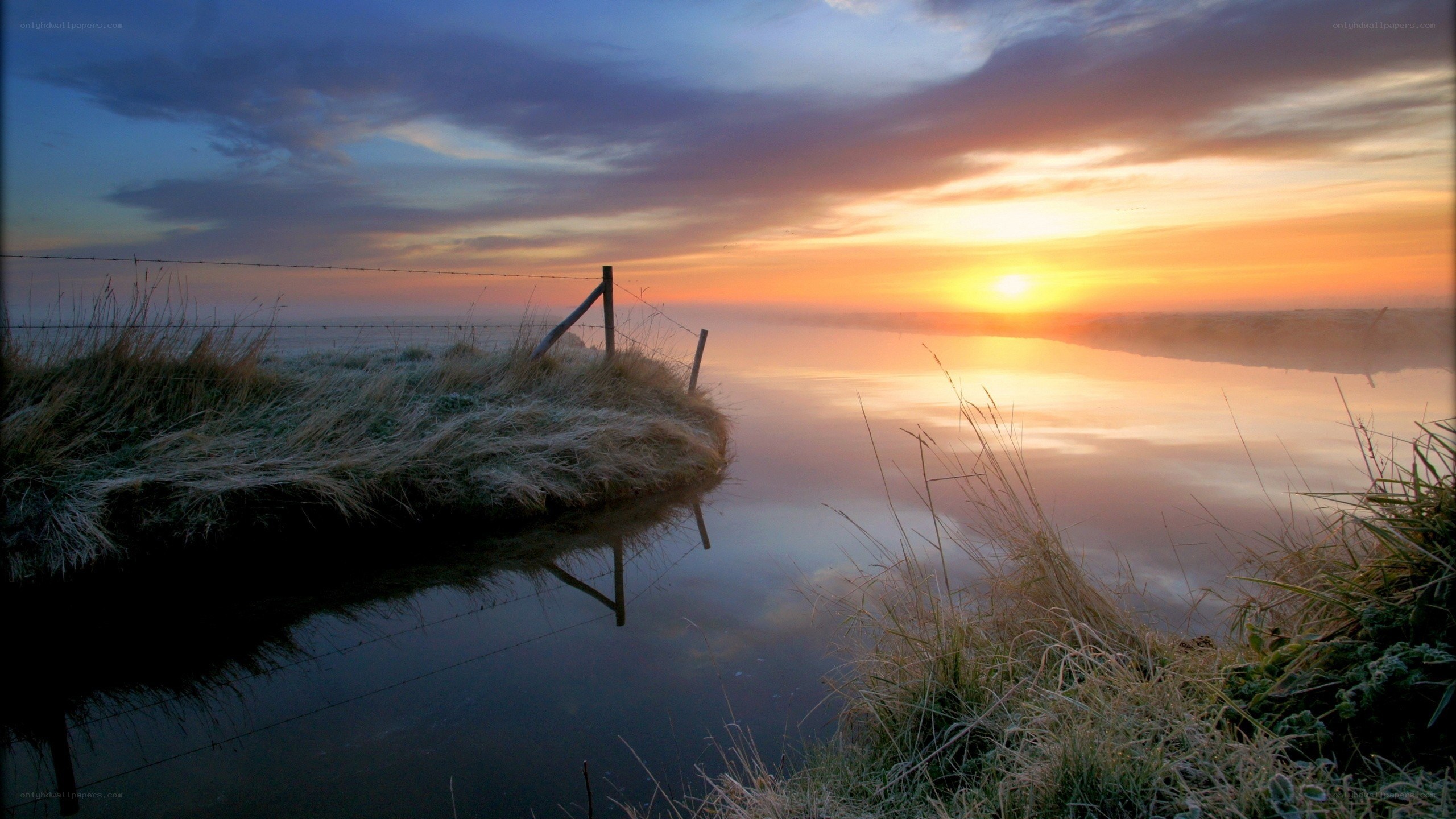 Sunrise over a misty river