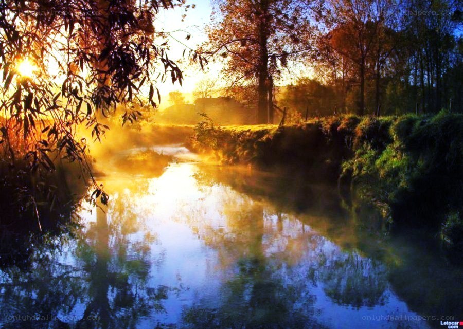 Sunrise over a misty river