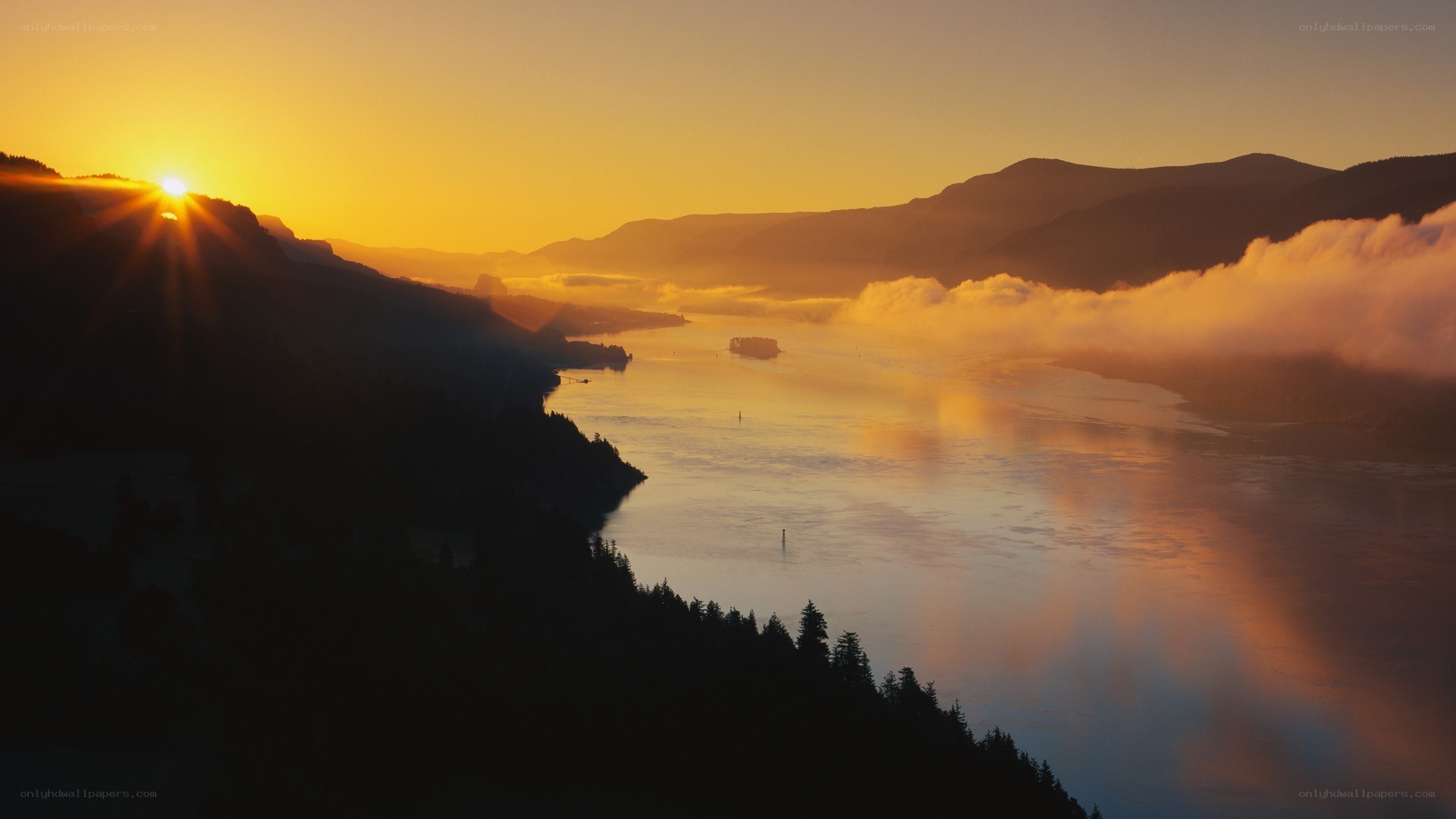 Sunrise over a misty river valley