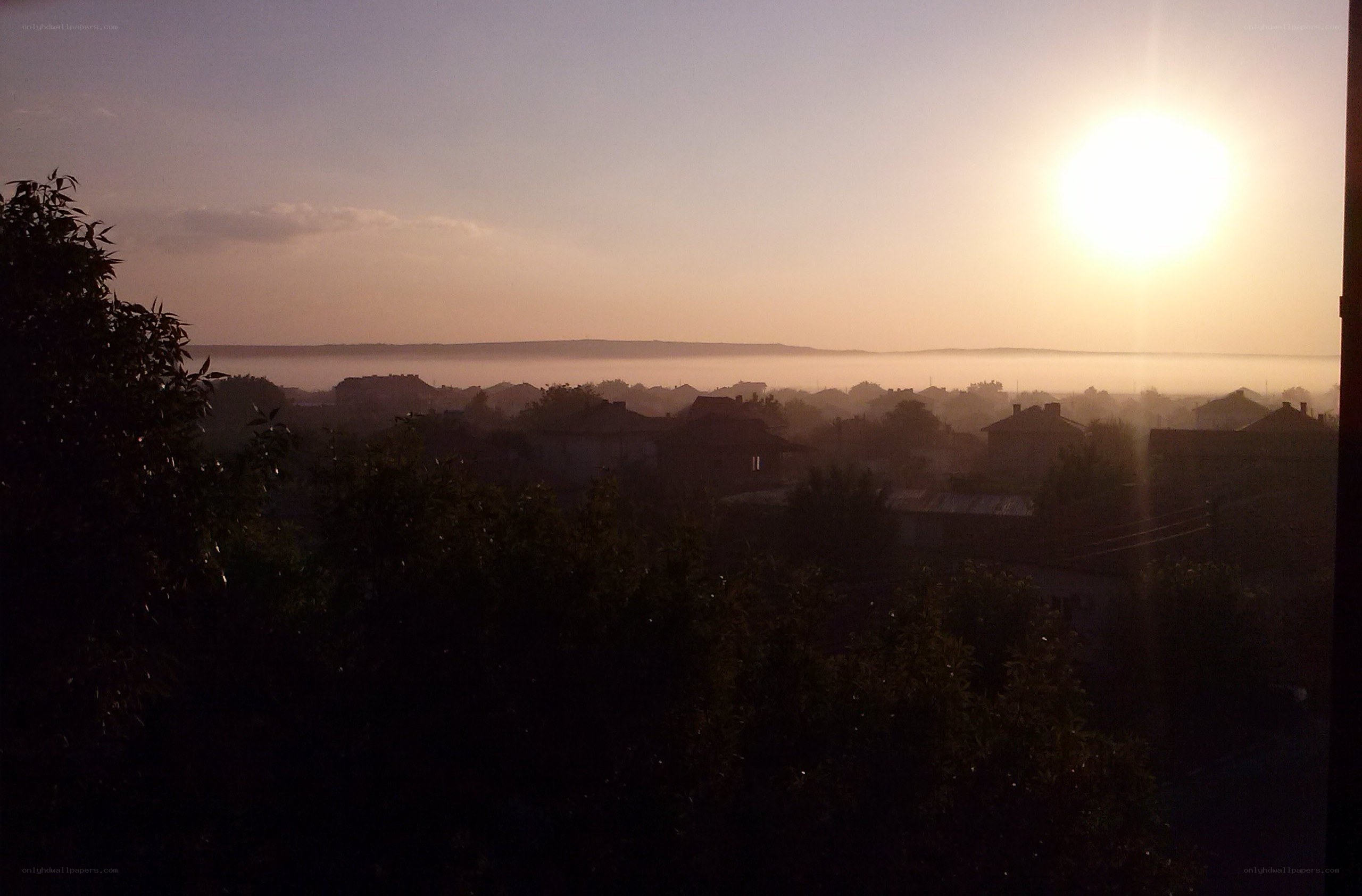 Sunrise over a misty town