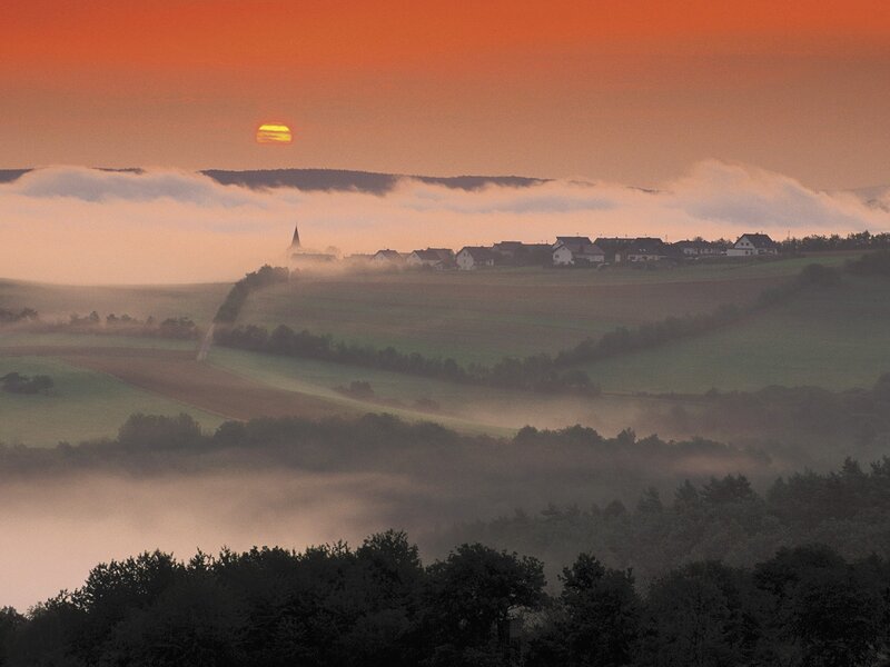 Sunrise over a misty village