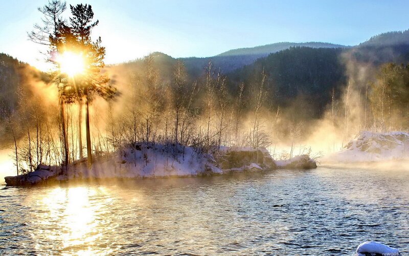 Sunrise over a misty winter lake
