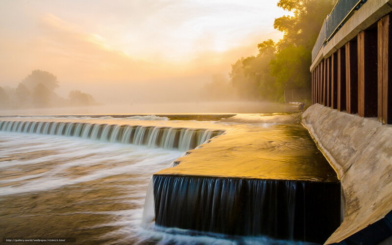 Sunrise over a river dam