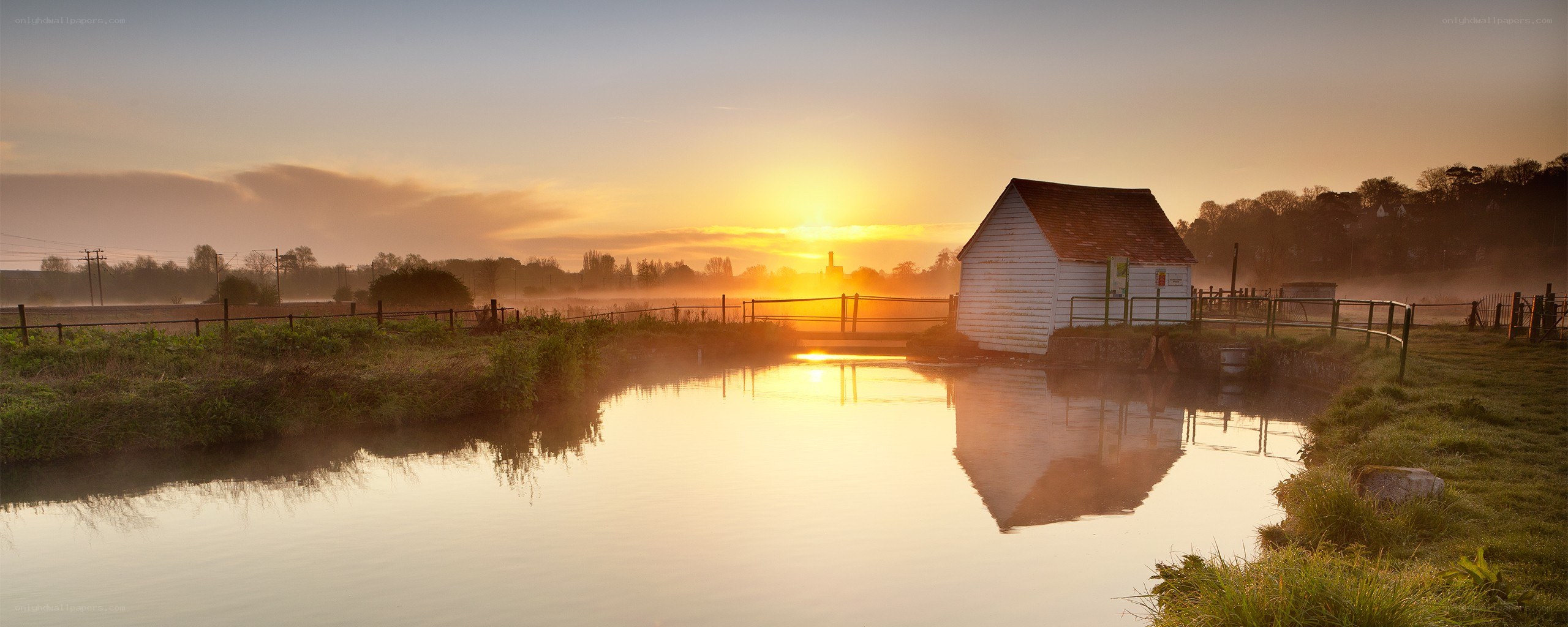 Sunrise over a river mill