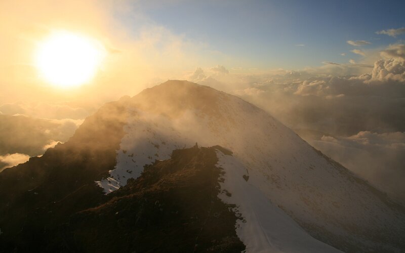 Sunrise over a snowy mountain peak