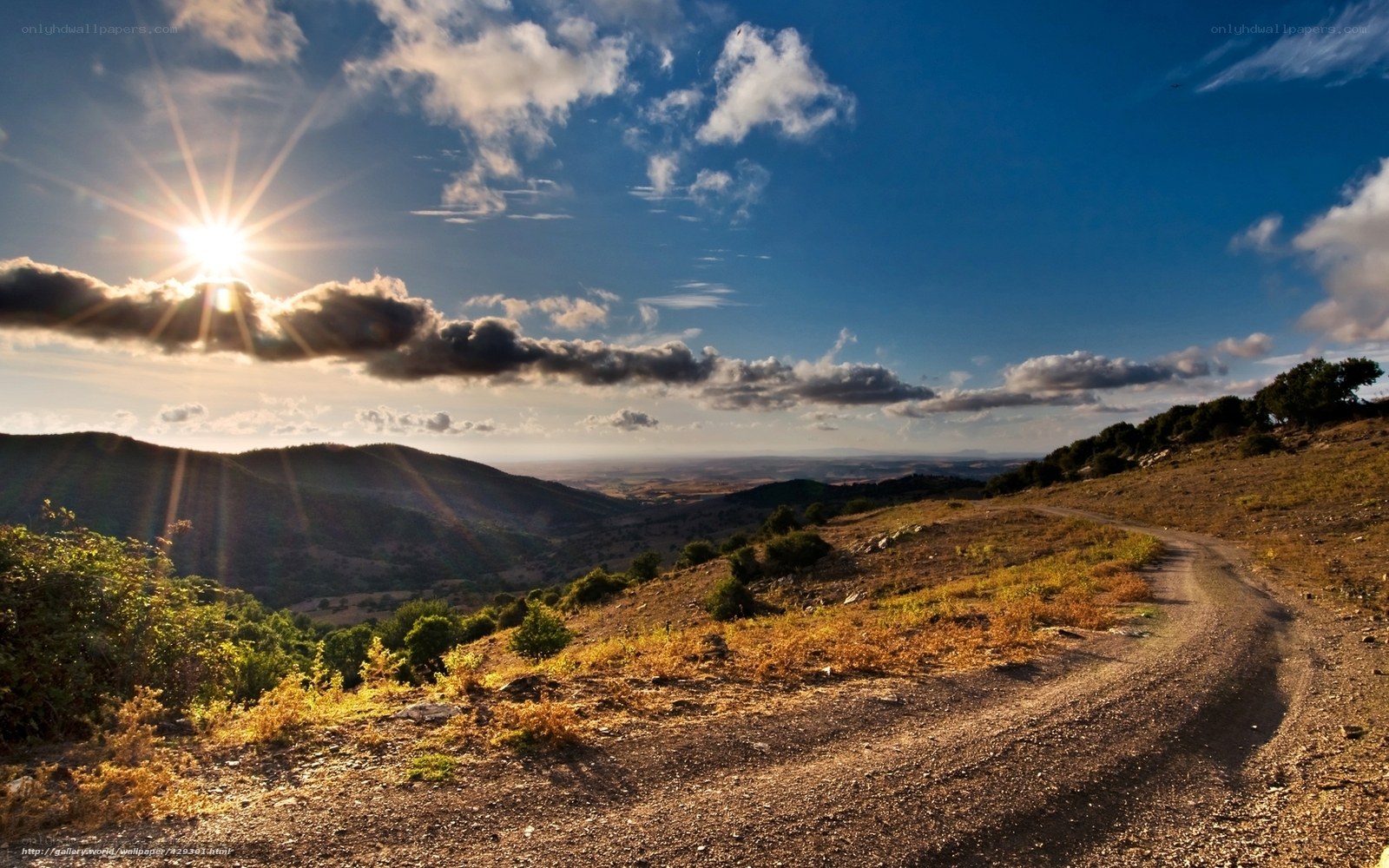 Sunrise over a winding dirt road