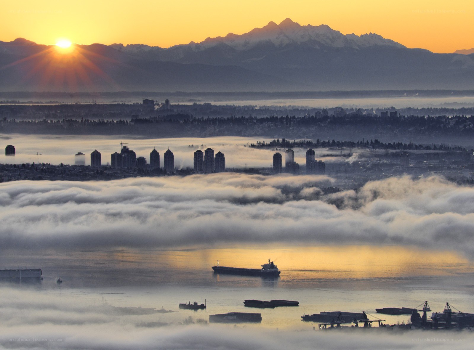 Sunrise over city and mountains
