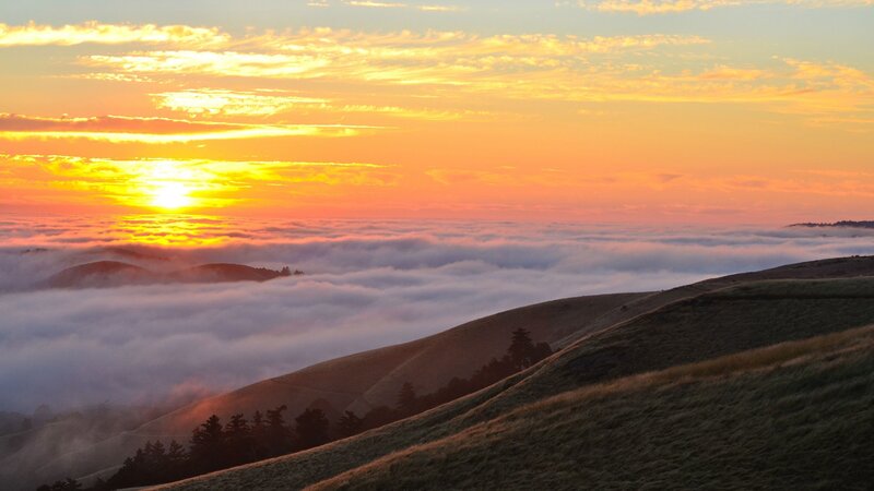 Sunrise over foggy hills