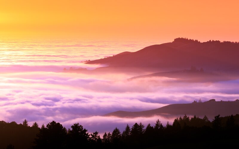 Sunrise over foggy hills