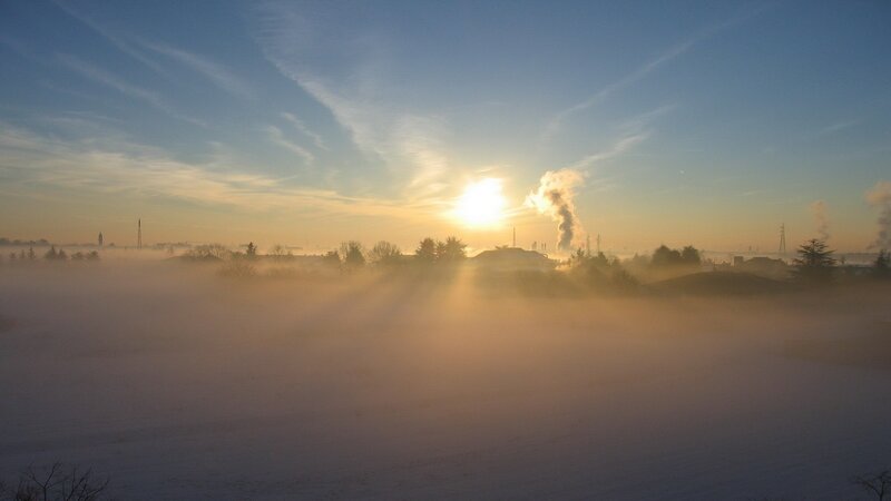 Sunrise over foggy landscape