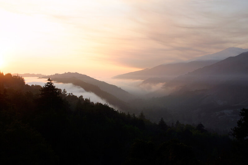 Sunrise over foggy mountain valley
