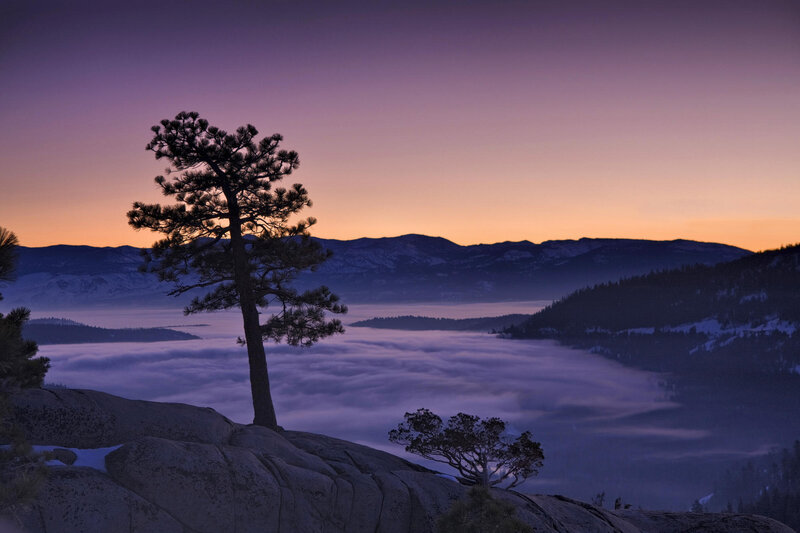 Sunrise over foggy mountain valley