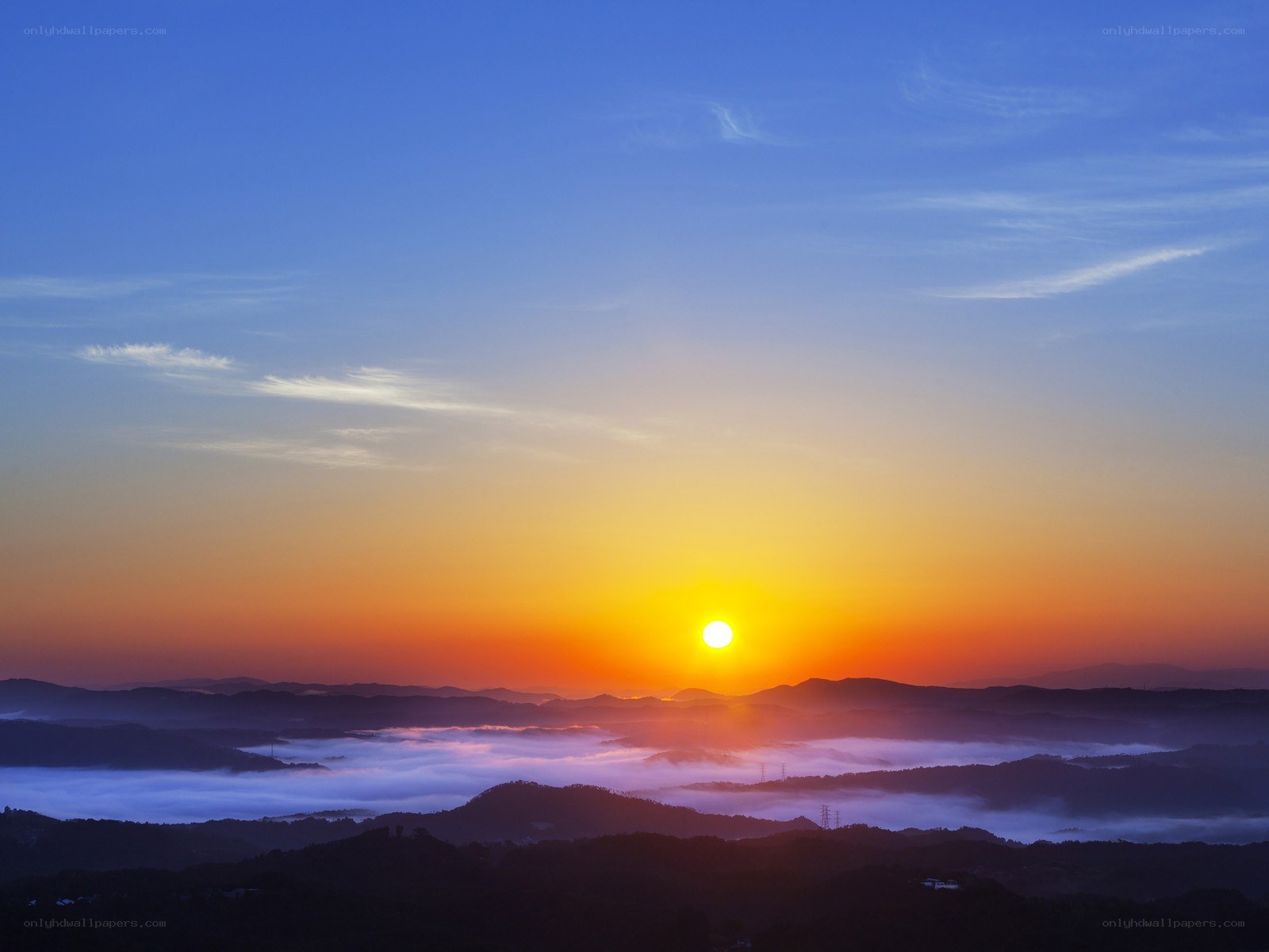 Sunrise over foggy mountains