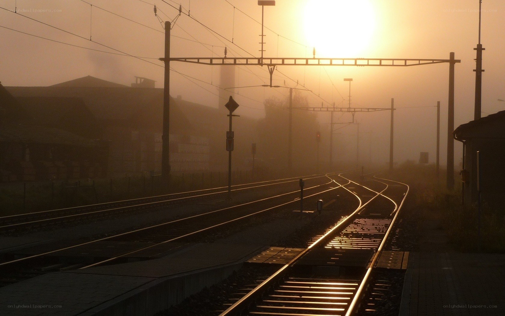 Sunrise over foggy train tracks