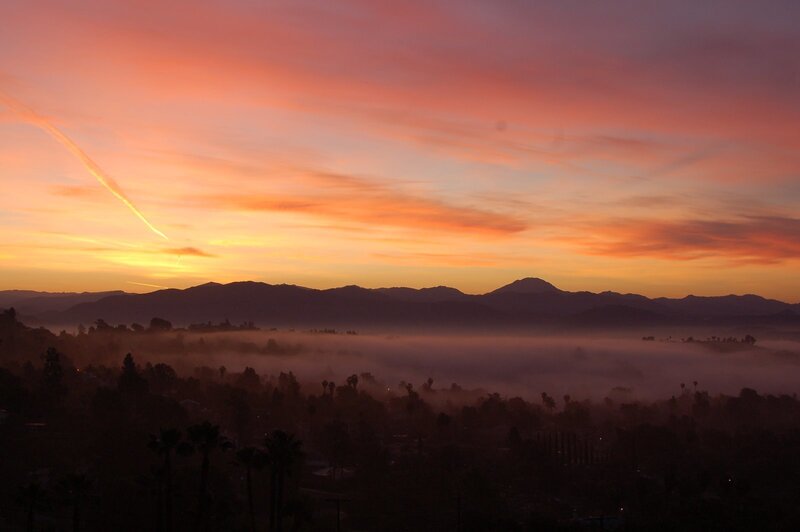 Sunrise over foggy valley