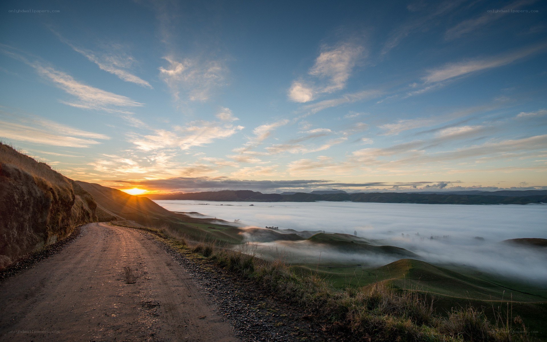 Sunrise over foggy valley