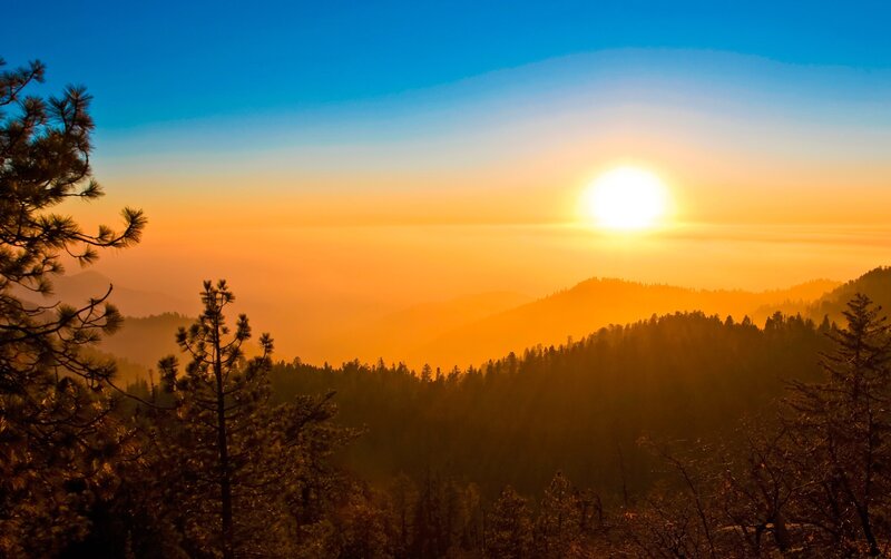 Sunrise over Forested Hills — Blue, Serene, Photograph, Trees, Mountains