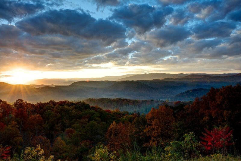Sunrise over forested mountains