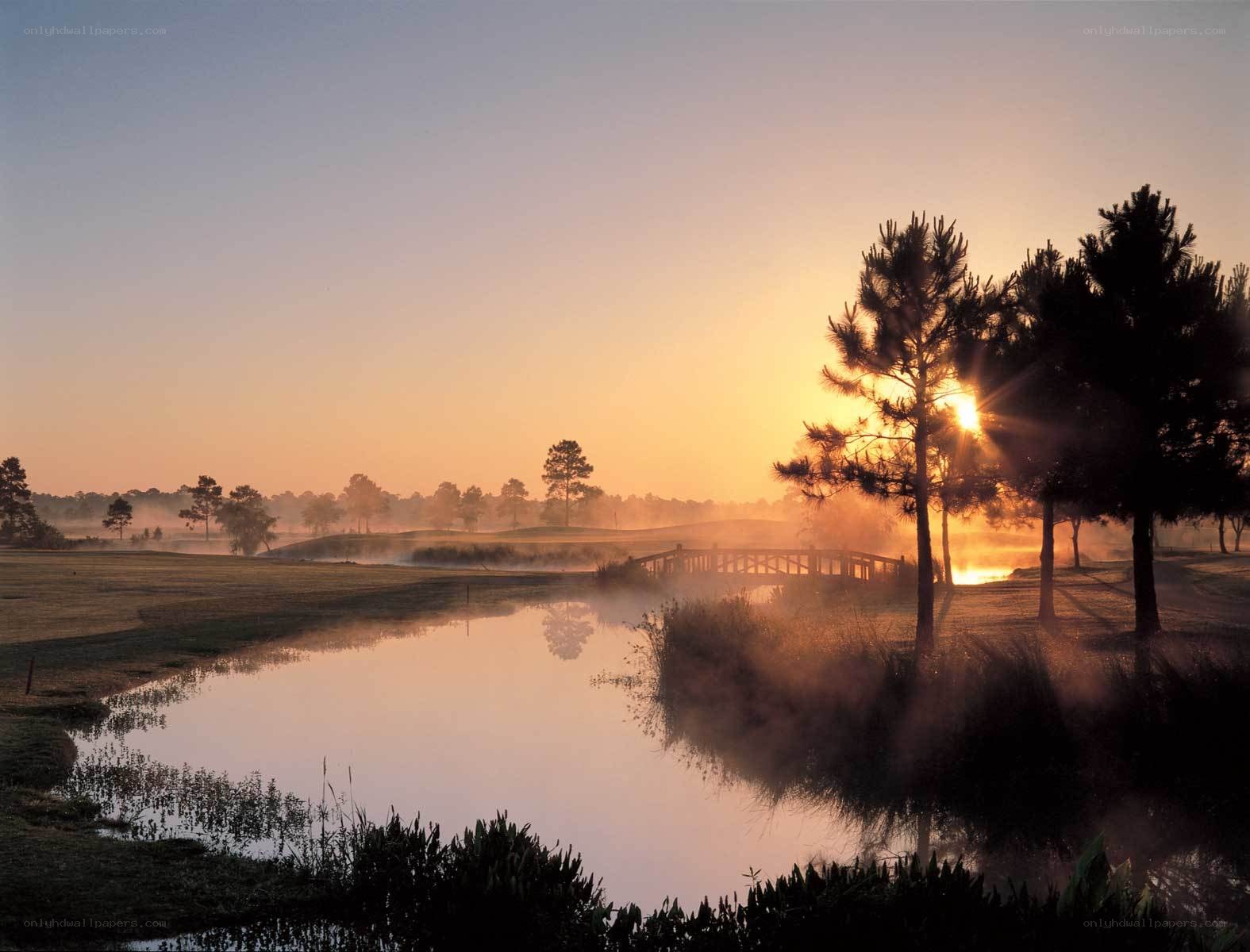 Sunrise over golf course pond