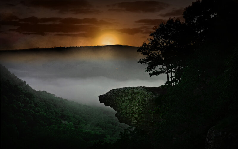 Sunrise over misty canyon