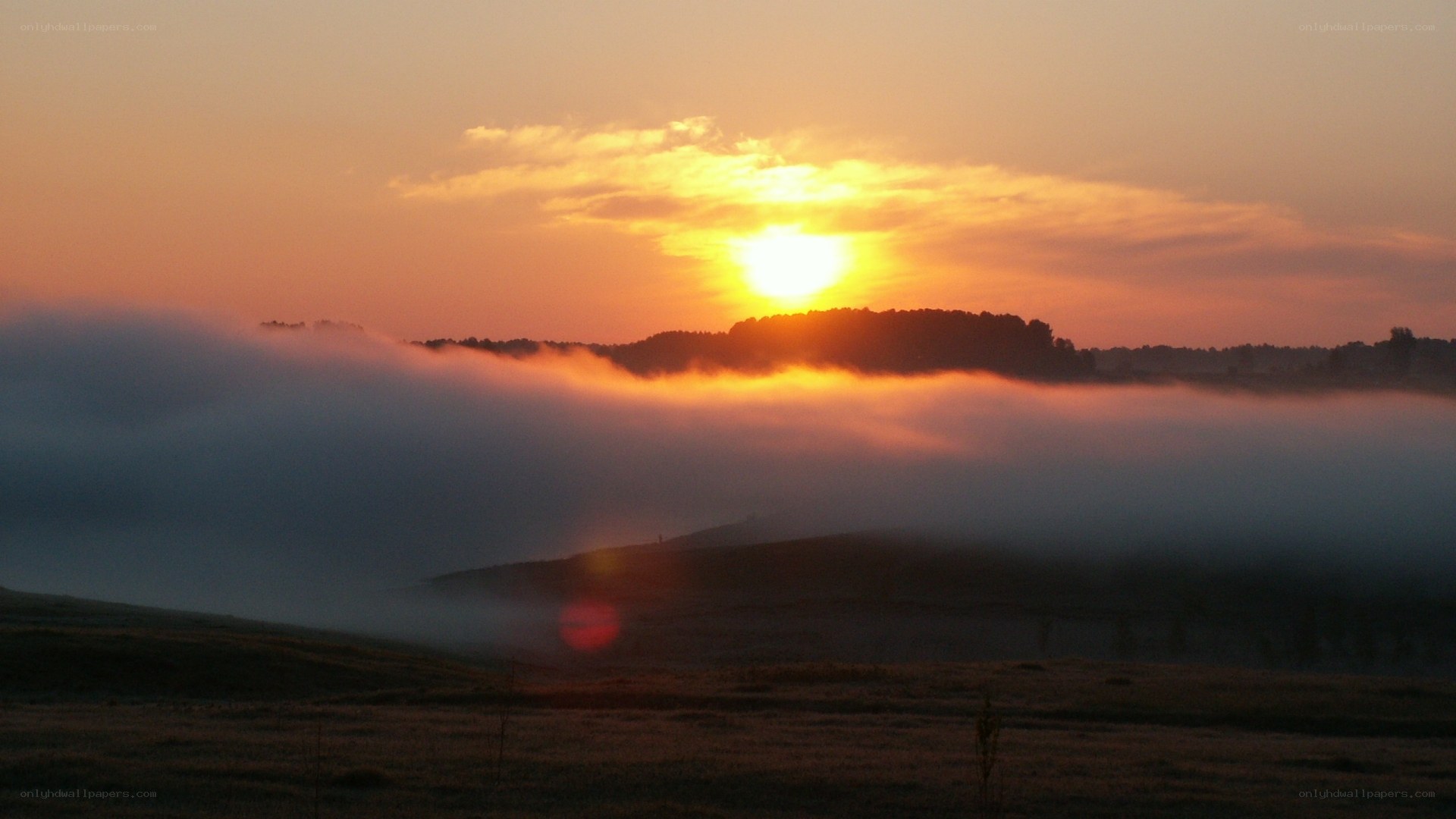 Sunrise over misty hills