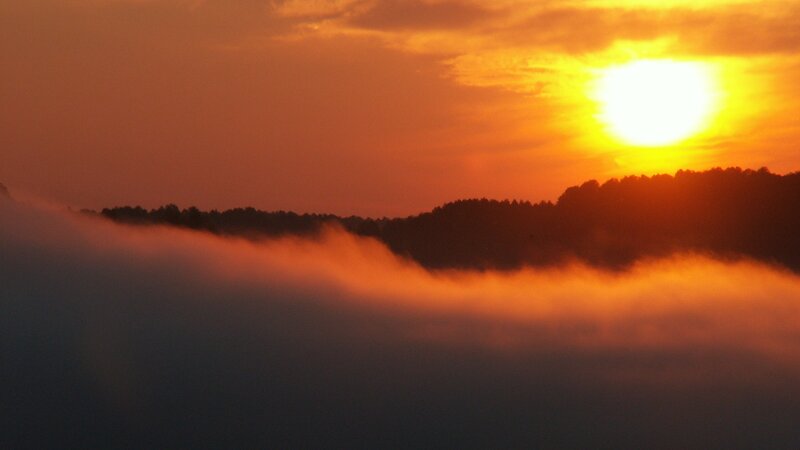 Sunrise over misty hills
