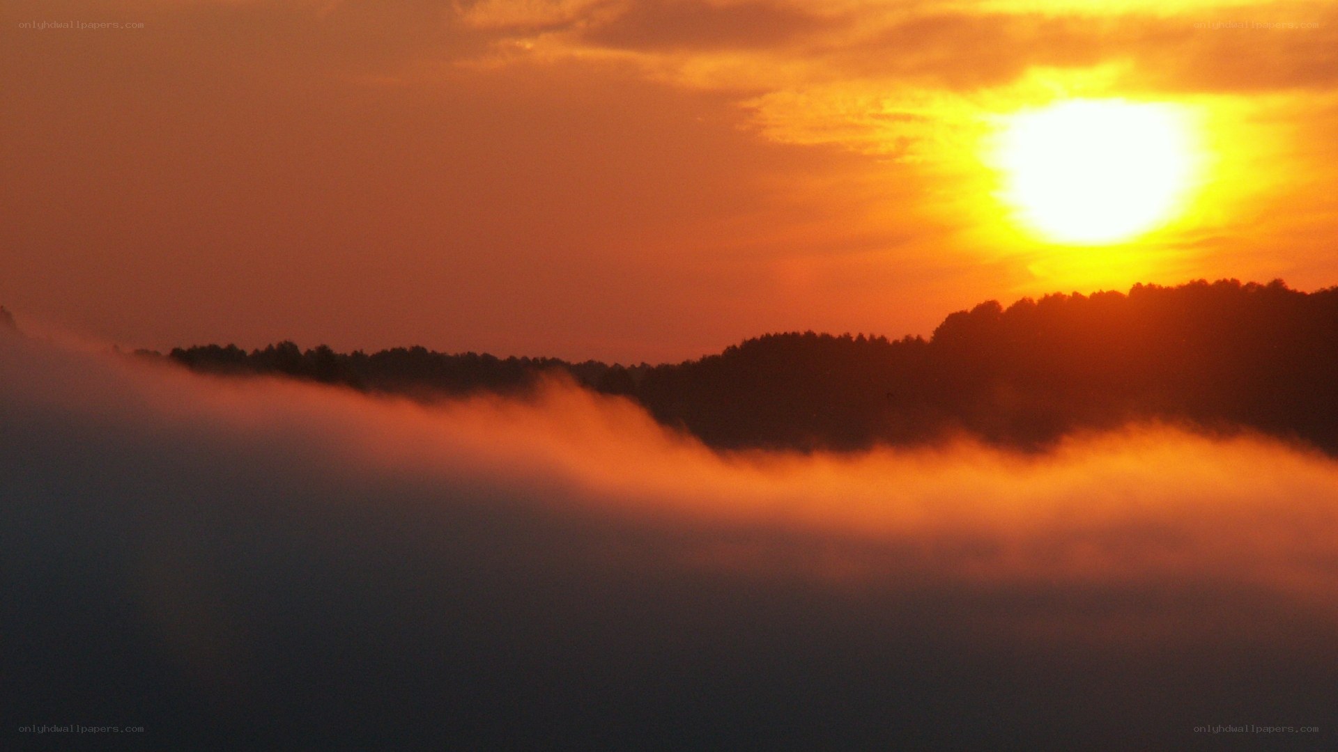 Sunrise over misty hills
