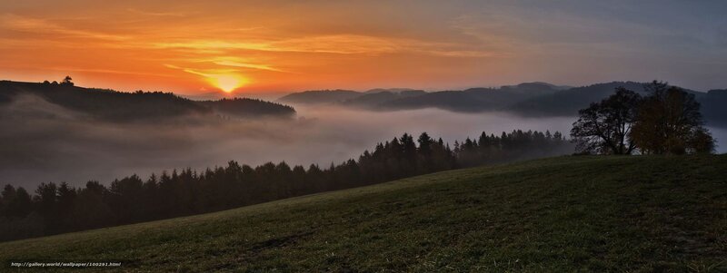 Sunrise over misty hills