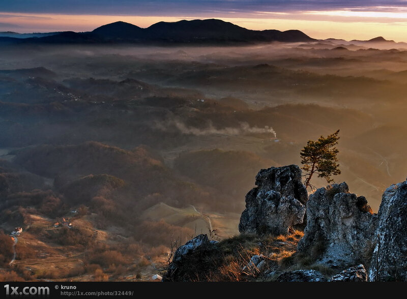 Sunrise over misty hills