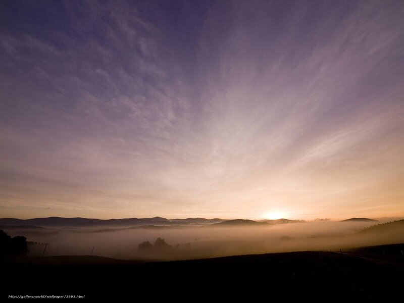 Sunrise over misty hills