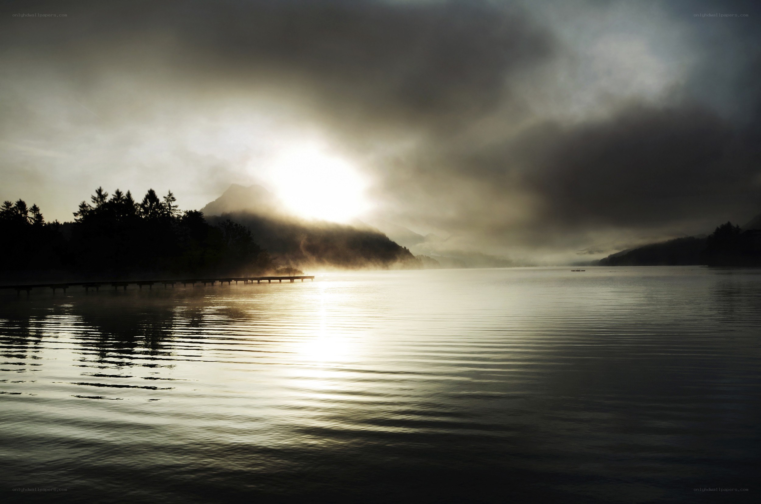 Sunrise over misty lake
