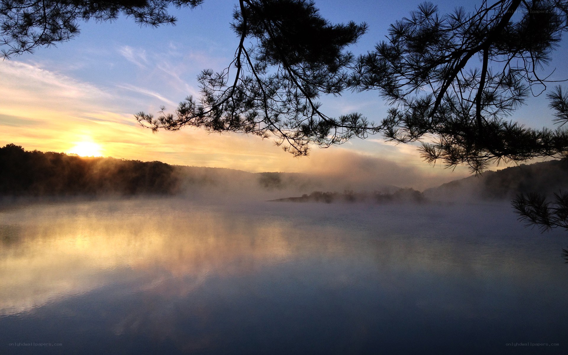 Sunrise over misty lake