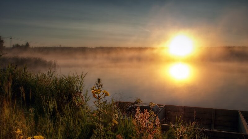 Sunrise over misty lake
