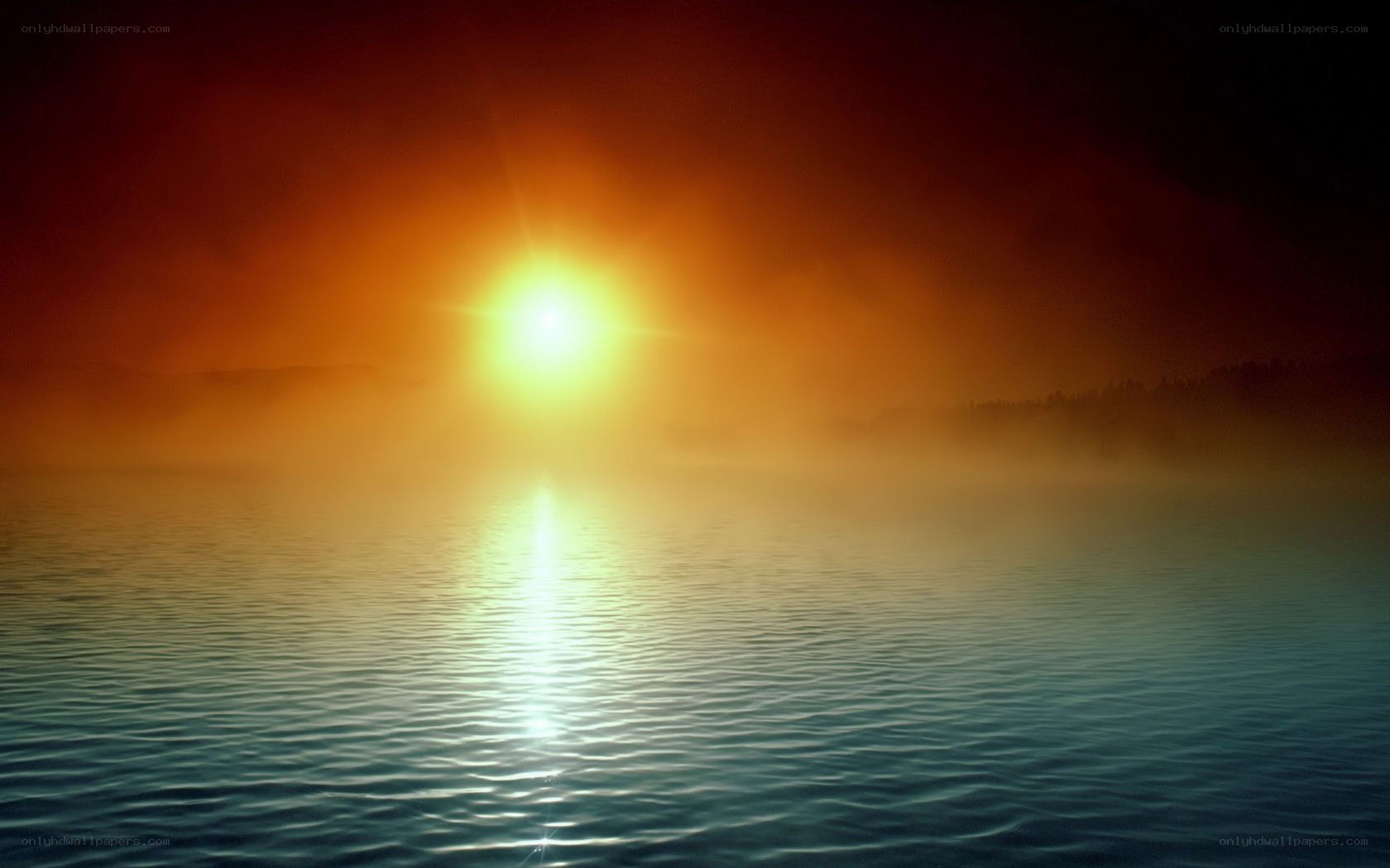 Sunrise over misty lake