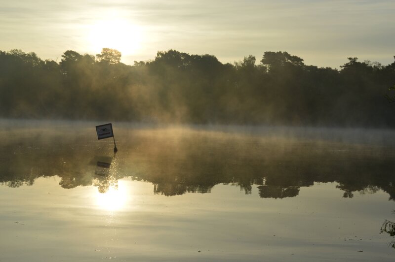 Sunrise over misty lake