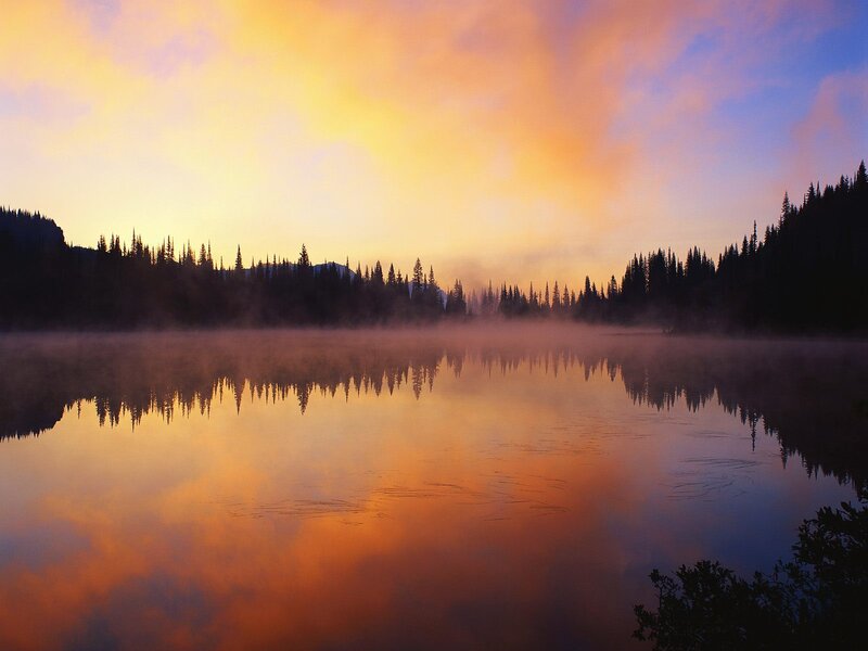 Sunrise over misty lake