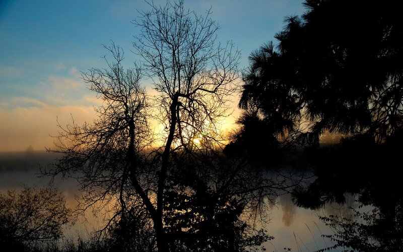 Sunrise over misty lake