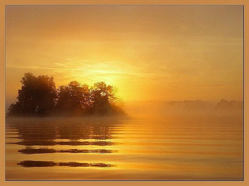 Sunrise over misty lake