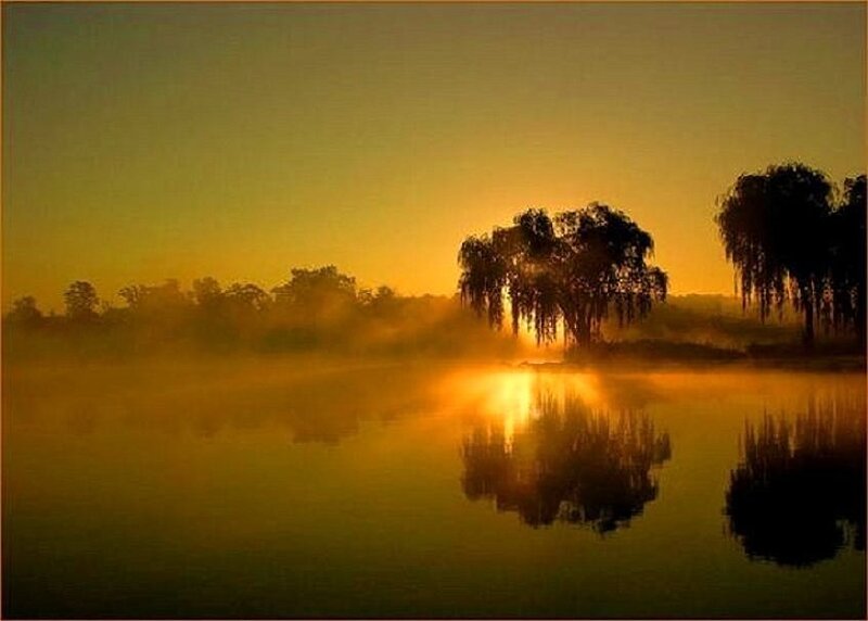 Sunrise over misty lake