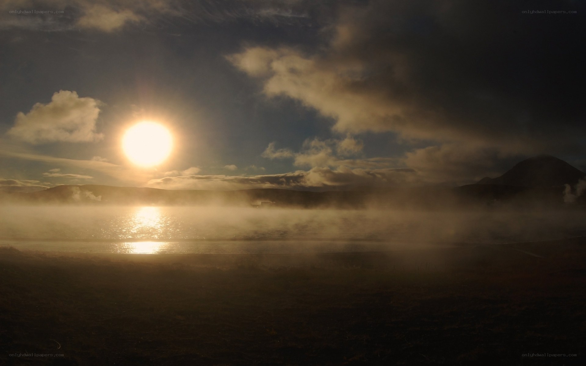 Sunrise over misty lake