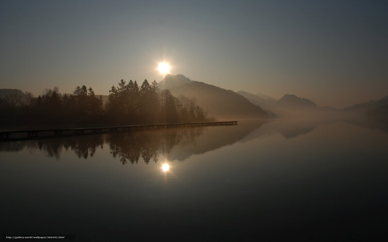 Sunrise over misty lake
