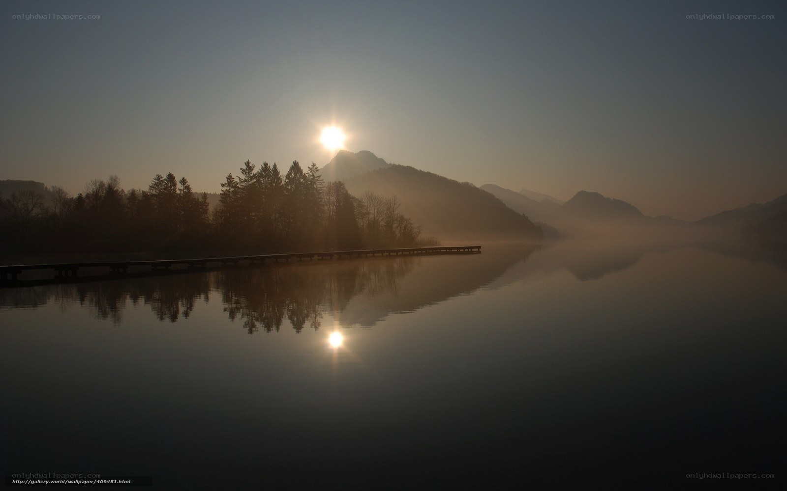 Sunrise over misty lake