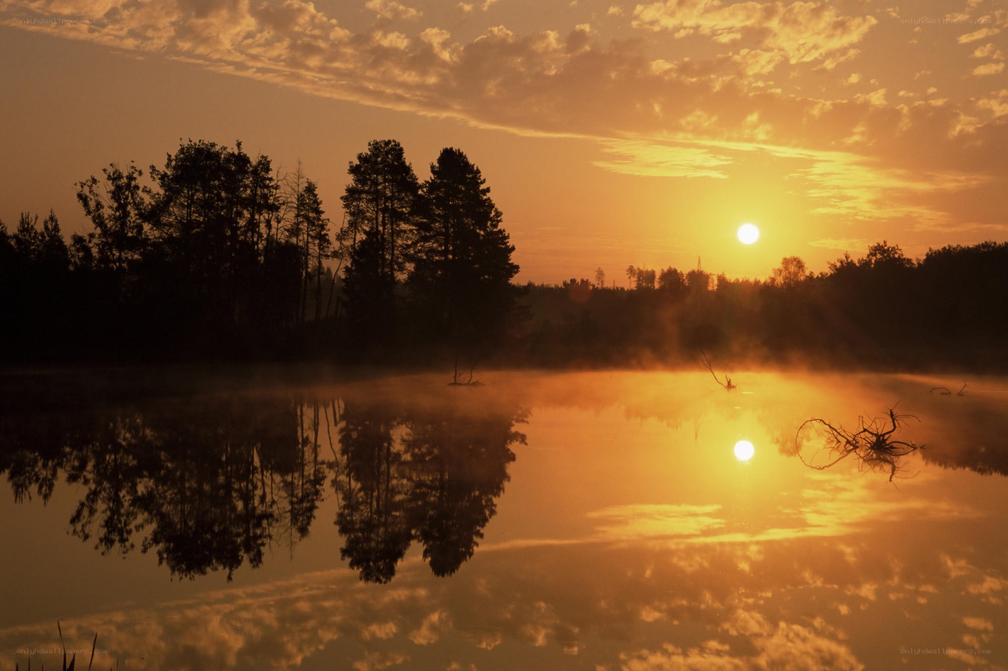 Sunrise over misty lake