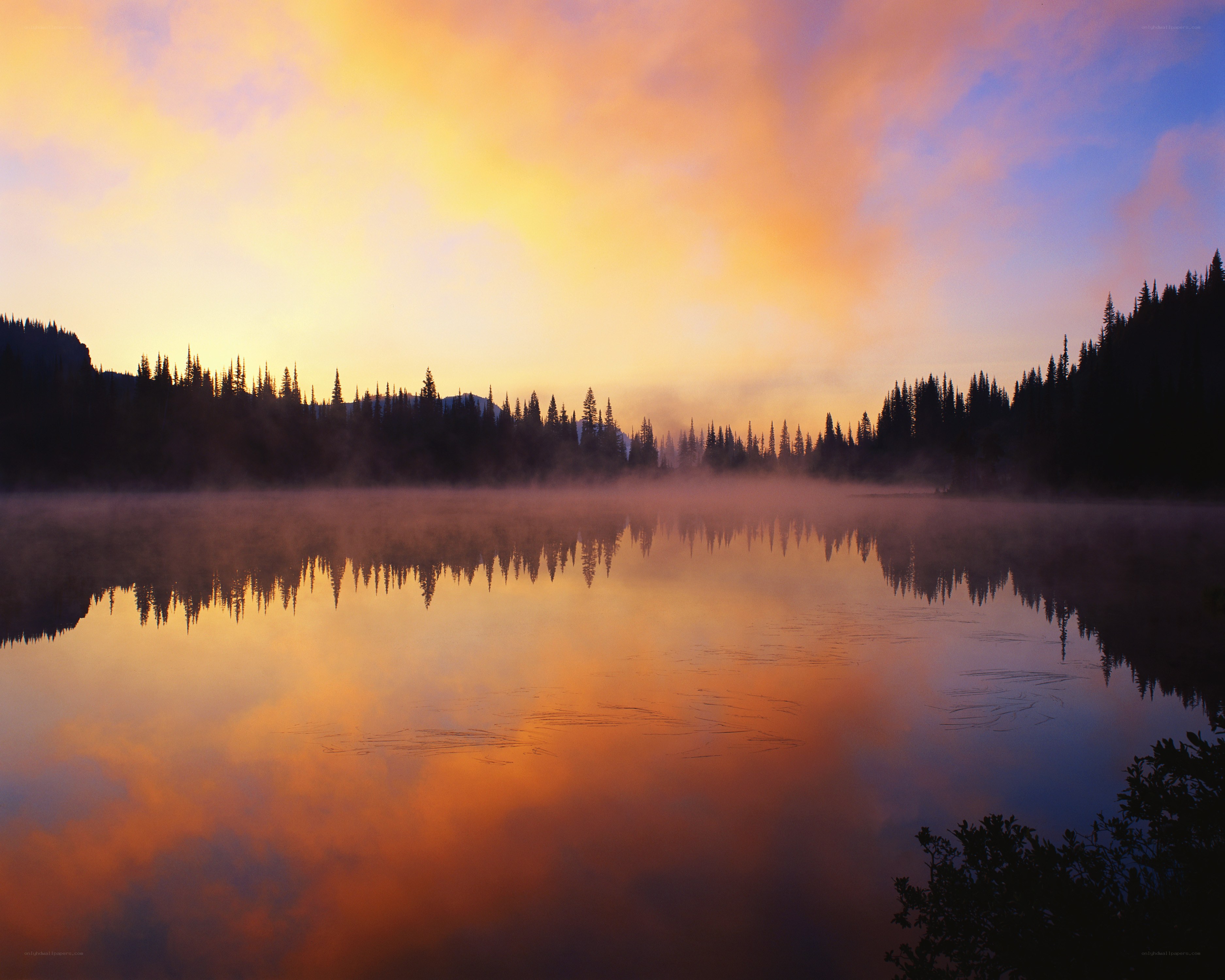 Sunrise over misty lake