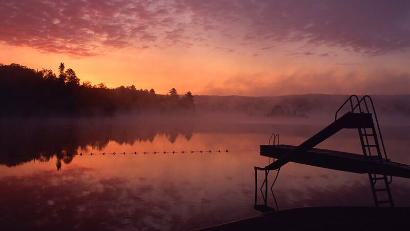 Sunrise over misty lake