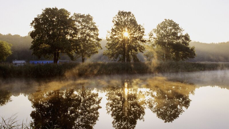 Sunrise over misty lake