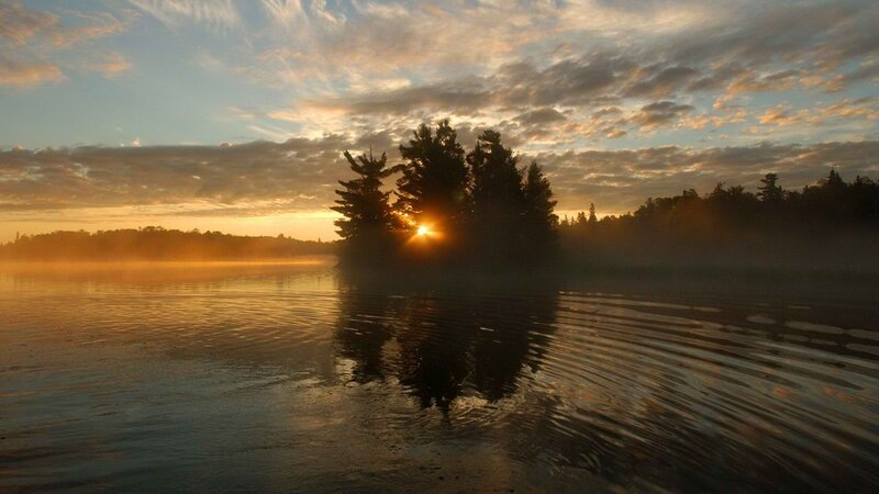 Sunrise over misty lake