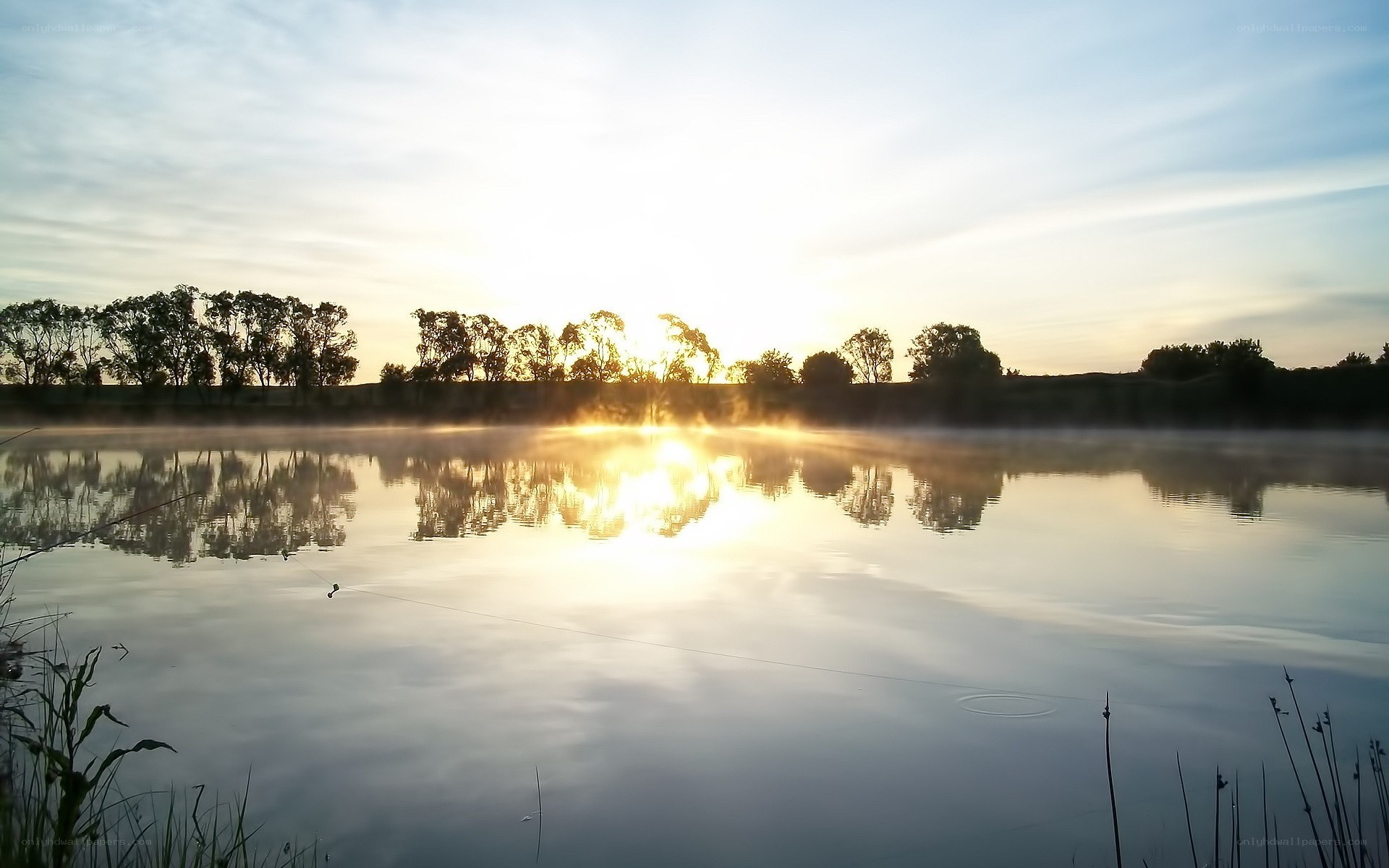 Sunrise over misty lake